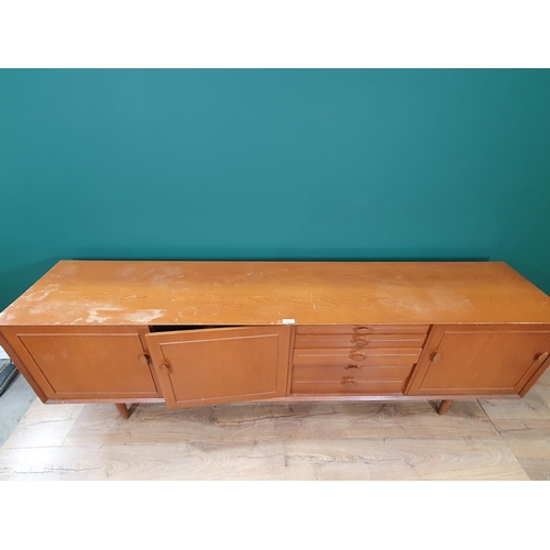 464 - A Mid Century Sideboard fitted pair of cupboard doors, five drawers and a fall front compartment, on... 