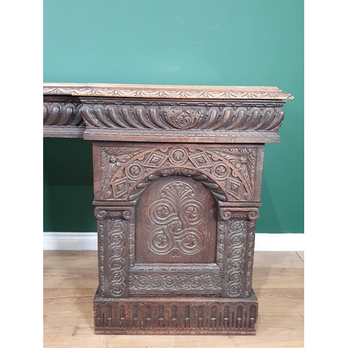 467 - A heavily carved oak Victorian Breakfront Pedestal Sideboard, the top fitted three drawers above pai... 