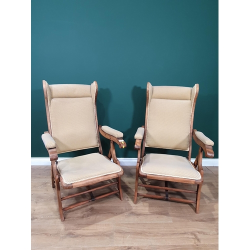 469 - A pair of beige and blue upholstered folding campaign style Armchairs.