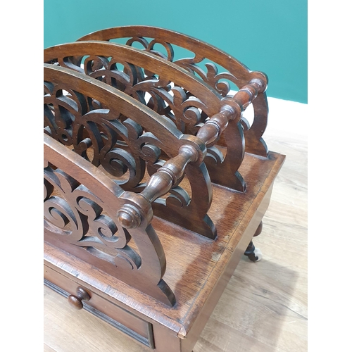 471 - A shaped and pierced mahogany Canterbury with single fitted drawer on turned supports and castors, 2... 