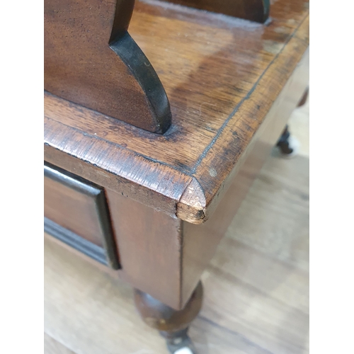 471 - A shaped and pierced mahogany Canterbury with single fitted drawer on turned supports and castors, 2... 