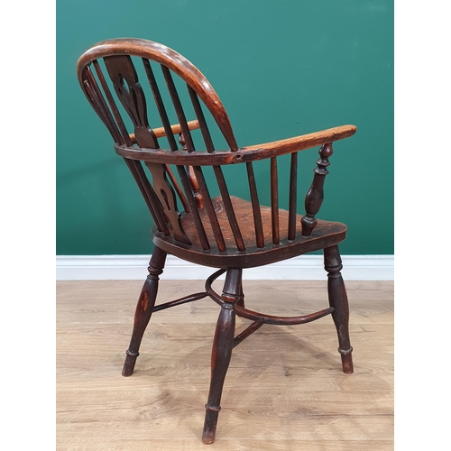 473 - A 19th Century ash and elm Windsor Elbow Chair with pierced splat back, turned supports and crinolin... 