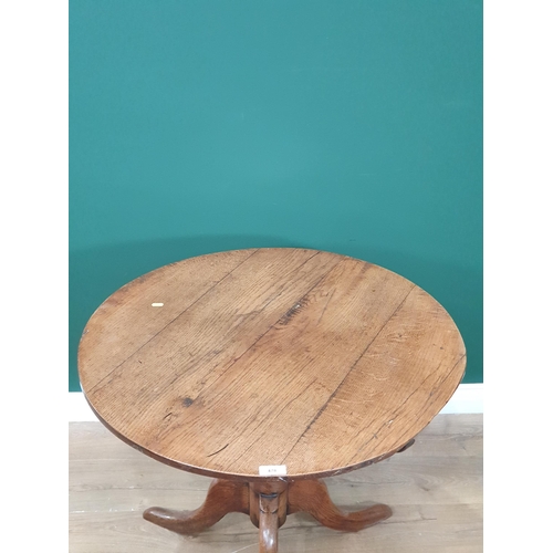 478 - An antique oak Circular Tilt Top Tripod Table on turned column and splayed supports, 32