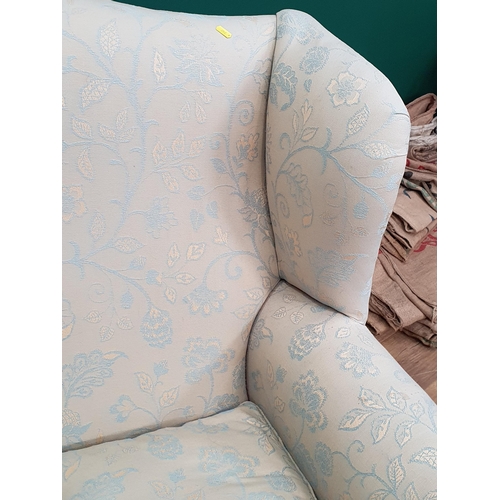 48 - A modern two Seater Sofa with floral and leafage patterns and a matching Wingback Armchair and Foots... 