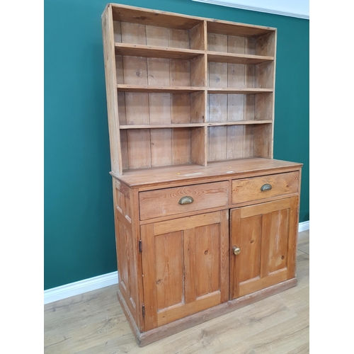 493 - A pine Dresser and Rack, the rack above pair of fitted drawers and pair of panel doors on plinth bas... 