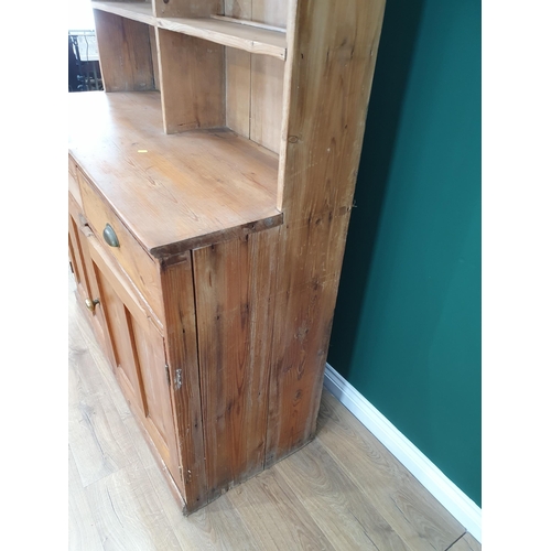 493 - A pine Dresser and Rack, the rack above pair of fitted drawers and pair of panel doors on plinth bas... 