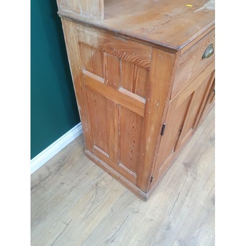 493 - A pine Dresser and Rack, the rack above pair of fitted drawers and pair of panel doors on plinth bas... 