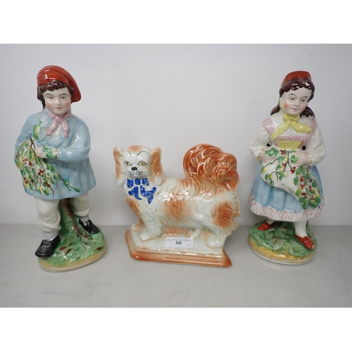 50 - A pair of pottery Figures of boy and girl with fruiting vines and painted details, 11in and a potter... 