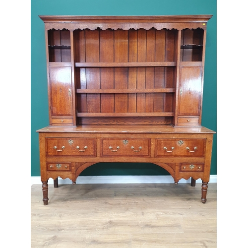 511 - A 19th Century oak and cross-banded Dresser and Rack, the base fitted three long drawers above two s... 