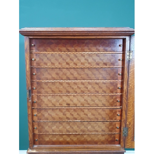 514 - An double Cabinet, the top section with glazed door enclosing eight fitted parquetry fronted drawers... 