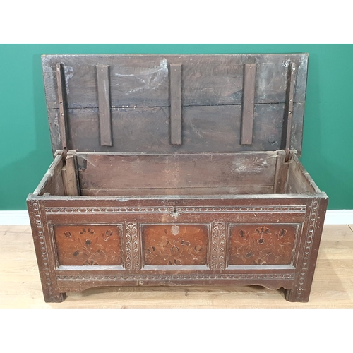 515 - A 17th Century oak and elm Coffer with two plank top, above carved and floral inlaid three panel fro... 