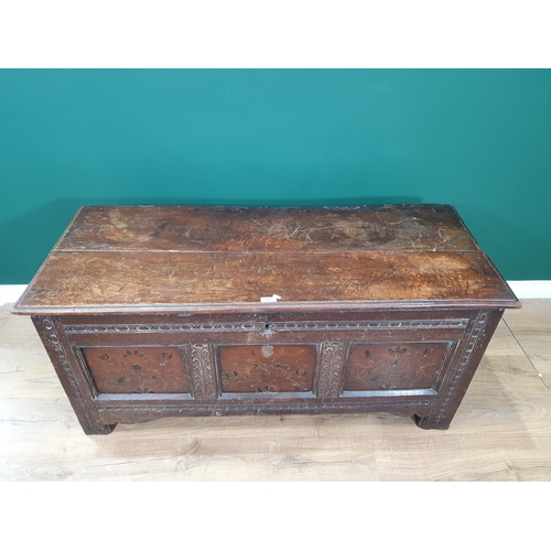 515 - A 17th Century oak and elm Coffer with two plank top, above carved and floral inlaid three panel fro... 