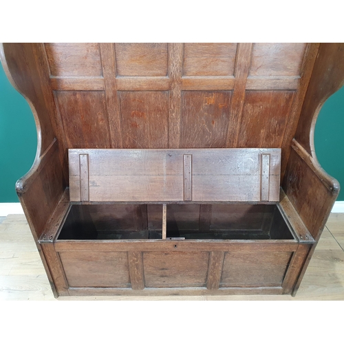 517 - An antique oak paneled back Box Seated Settle, 4ft 7in Wide x 4ft 9in High x 1ft 7in Deep.