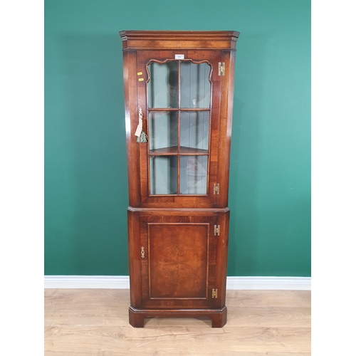 533 - A reproduction walnut Corner Cupboard with glazed upper section and door below, 5ft 9in H