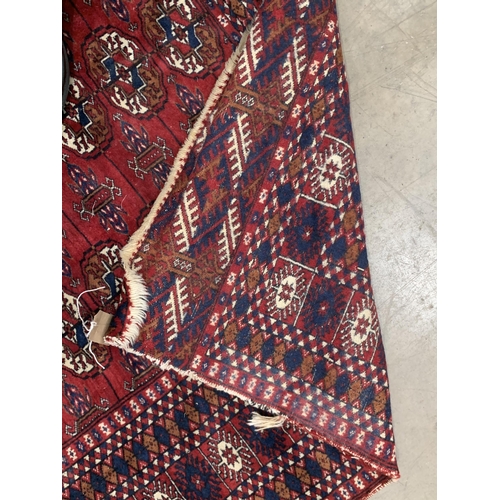 543 - A Pakistan Bokhara Rug with three rows of medallions on a red and maroon ground, 6ft x 4ft 6ft x 4ft... 