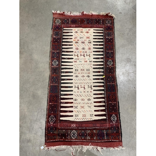 543 - A Pakistan Bokhara Rug with three rows of medallions on a red and maroon ground, 6ft x 4ft 6ft x 4ft... 