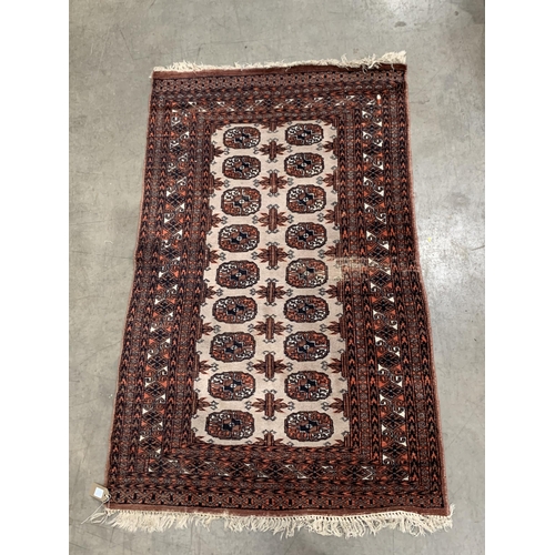 543 - A Pakistan Bokhara Rug with three rows of medallions on a red and maroon ground, 6ft x 4ft 6ft x 4ft... 