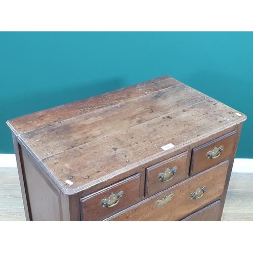 560 - An 18th Century oak Chest of three short above two long drawers with panelled ends on bracket feet, ... 