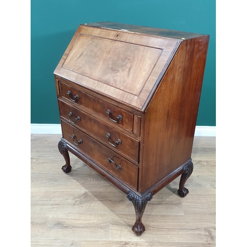 586 - A reproduction mahogany Bureau, the fall front enclosing pigeon hole and drawer interior above three... 