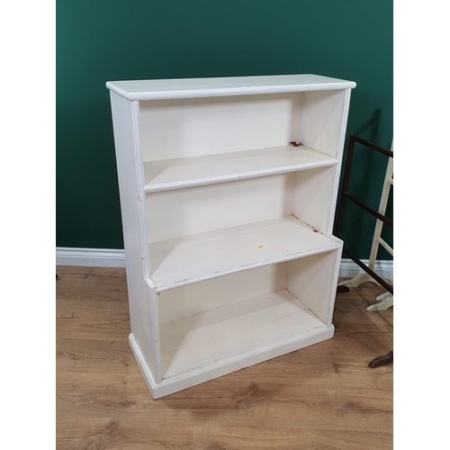 590 - A white painted open Bookcase on plinth base, 2ft 7