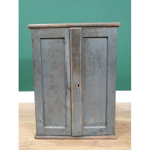 6 - A painted Cabinet with panelled doors enclosing four short and four long fitted  drawers, 1ft 10