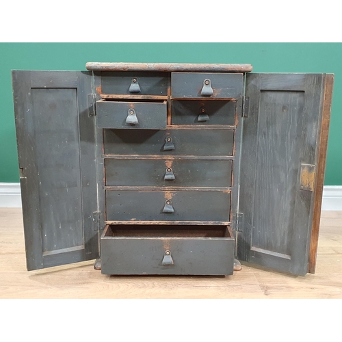 6 - A painted Cabinet with panelled doors enclosing four short and four long fitted  drawers, 1ft 10