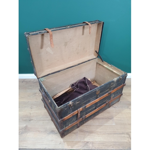 604 - A wood and metal bound Steamer Trunk/Chest with leather carry handles and straps, and various travel... 