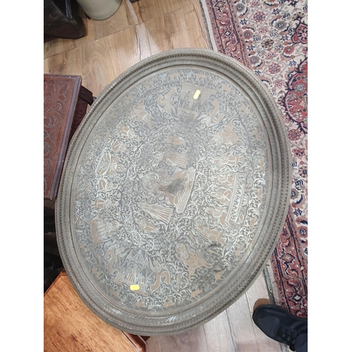 607 - An Eastern brass Tray top Table, a mahogany Cake Stand A/F,  an oval floral inlaid Tray, two Standar... 