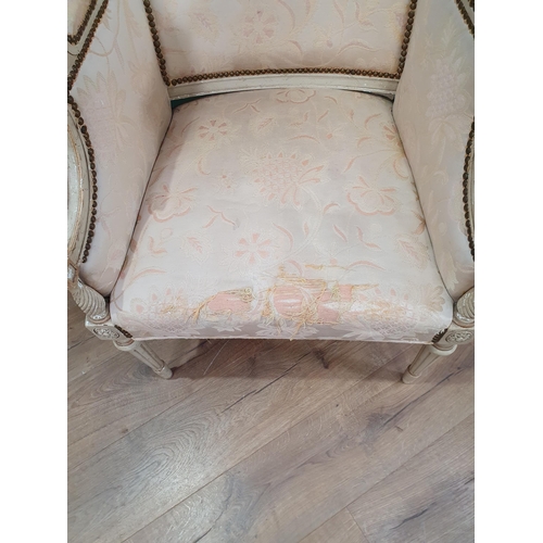 7 - A French Style cream painted Elbow Chair with floral upholstery on turned front supports.