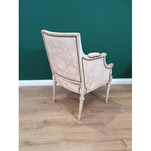 7 - A French Style cream painted Elbow Chair with floral upholstery on turned front supports.