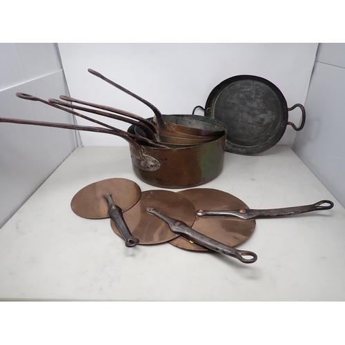 81 - A set of five antique copper graduated Saucepans and three Lids with iron handles, and a Frying Pan