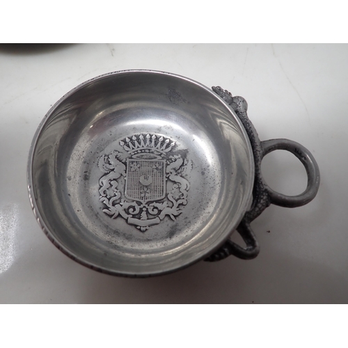 83 - Two antique pewter Wine Tasters with coats of arms and loop handles, three Plates, two Plate Warmers... 