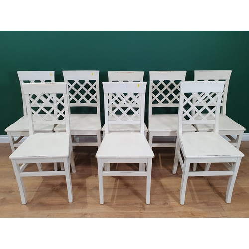 9 - A set of eight white painted Dining Chairs with lattice backs on squared supports and stretchers