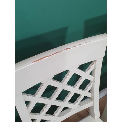 9 - A set of eight white painted Dining Chairs with lattice backs on squared supports and stretchers