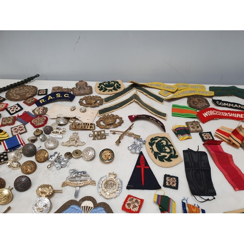 225 - A bag of Military Badges and other items including SAS Belt, Cloth Badges, Royal Engineers Cap Badge... 