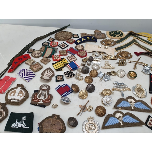 225 - A bag of Military Badges and other items including SAS Belt, Cloth Badges, Royal Engineers Cap Badge... 