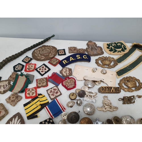 225 - A bag of Military Badges and other items including SAS Belt, Cloth Badges, Royal Engineers Cap Badge... 