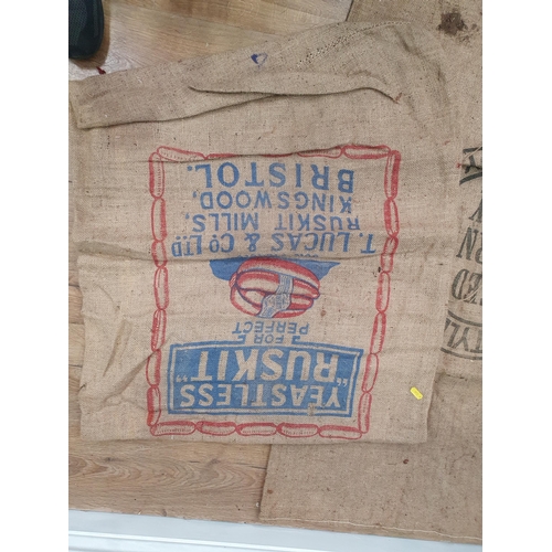 286 - Five hessian Sacks with various advertising logos (some repairs).