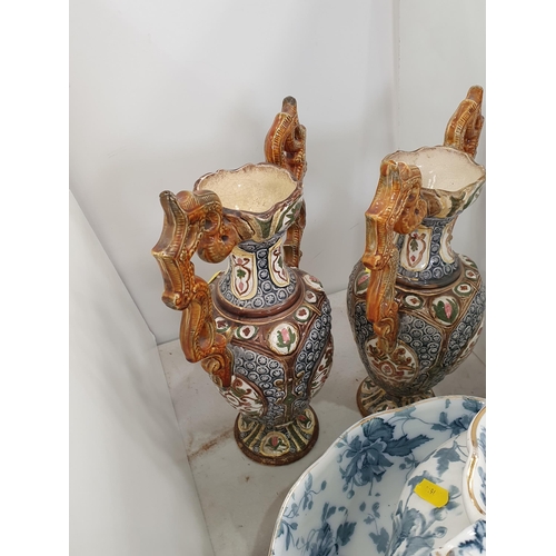 330 - A blue and white Toilet Jug and Bowl and a pair of Continental pottery two handled Vases, 15in H A/F