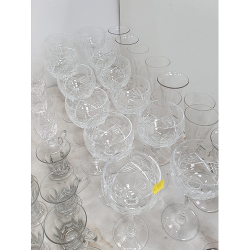 340 - A quantity of glassware including , stemmed Wines, one dozen Hock Glasses, Champagne Flutes, Custard... 