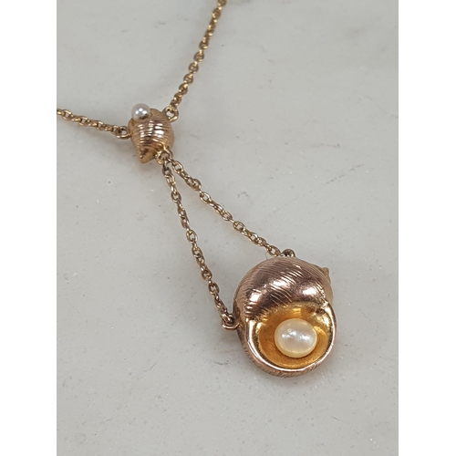 188 - A gold shell Pendant set seed pearls on fine chain stamped 9ct, approx 2.70gms