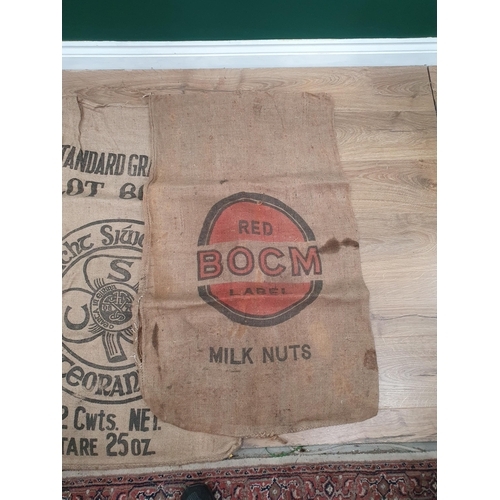 286 - Five hessian Sacks with various advertising logos (some repairs).