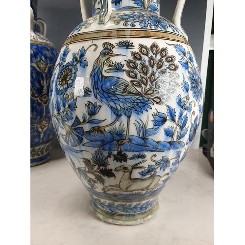 479 - A blue glazed ceramic four handled Vase with bands of floral decorations A/F 19