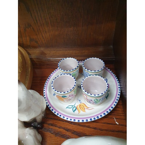 824 - A Poole pottery Vase, a Poole Egg Cup Stand and four Egg Cups, two Beswick, two Beswick models of Si... 