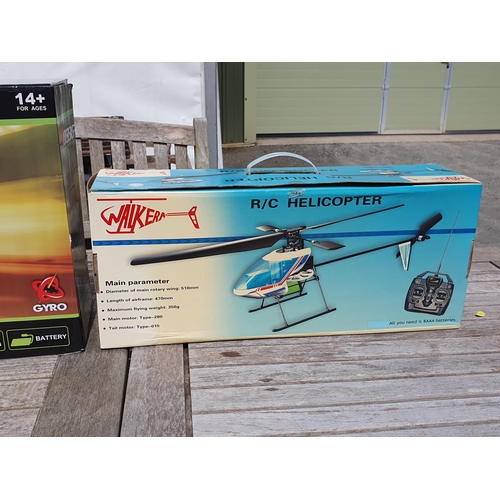 197 - Two boxed Syma radio controlled Helicopters, a Piccoo 2 radio controlled Helicopter Game and a Walke... 