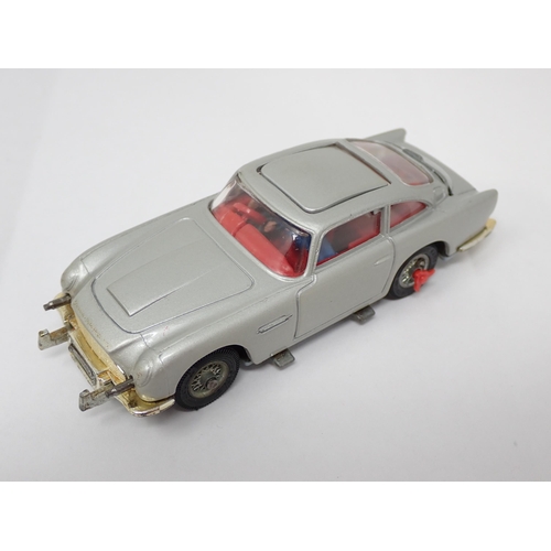 225 - A boxed Corgi Toys No.270 James Bond Aston Martin DB5 with red interior and both figures, lacking in... 