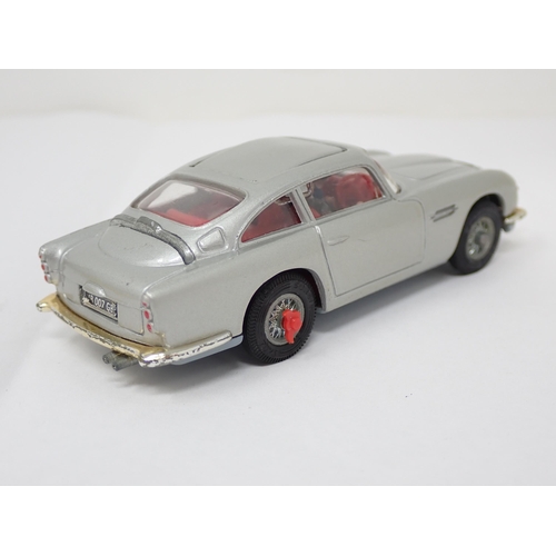 225 - A boxed Corgi Toys No.270 James Bond Aston Martin DB5 with red interior and both figures, lacking in... 