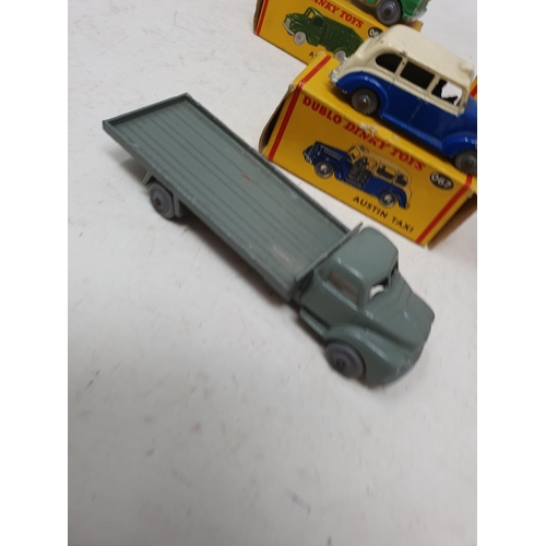 738 - A boxed Dublo Dinky Toys 066 Bedford Flat Truck, boxed 064 Austin Lorry, boxed 067 Austin Taxi, unbo... 