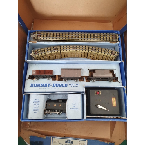 749 - Four Hornby Dublo 3-rail Goods Sets, boxes damaged and contents incomplete