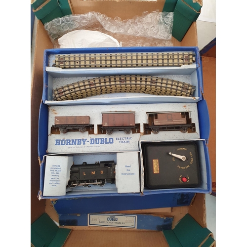 749 - Four Hornby Dublo 3-rail Goods Sets, boxes damaged and contents incomplete